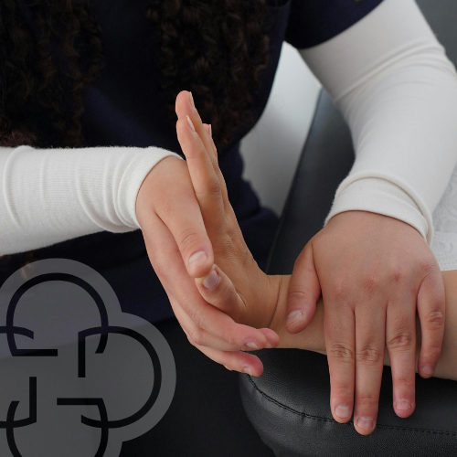 Physiotherapist doing movilization in a hand with spasticity